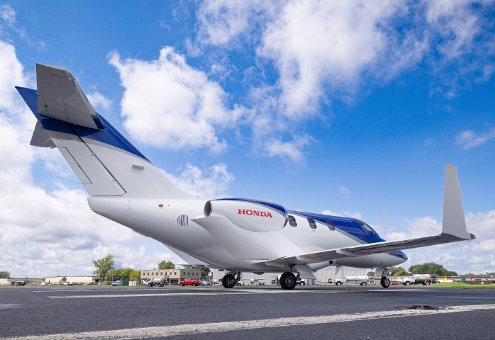 private aircraft on tarmac with blue sky